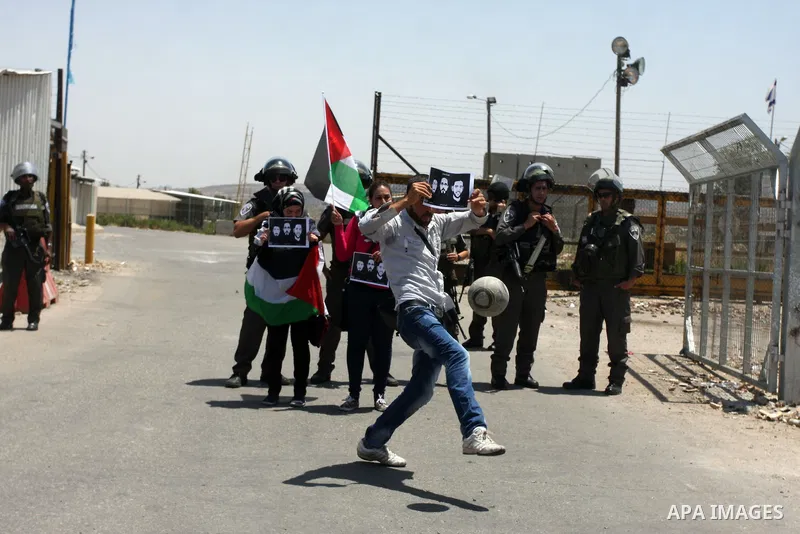 Israeli police keep guard as Palestinian protestors play football in front of Ofer prison, near the city of Ramallah, in solidarity with jailed Palestinian football player Mahmud Sarsak and prisoners Akram Rikhawi and Sa...