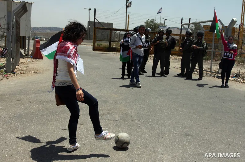 Israeli police keep guard as Palestinian protestors play football in front of Ofer prison, near the city of Ramallah, in solidarity with jailed Palestinian football player Mahmud Sarsak and prisoners Akram Rikhawi and Sa...