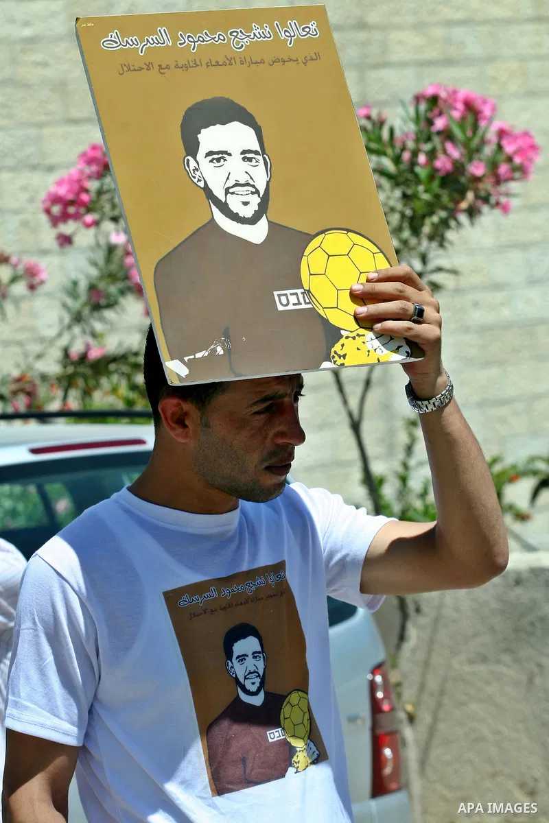 Palestinian protestors hold pictures of Palestinian prisoners Mahmoud Al-Sarsak and Akram al-Rikhawi, whose are still refusing food for 86 days after a deal was made to end a mass prisoner hunger strike, during a demonst...