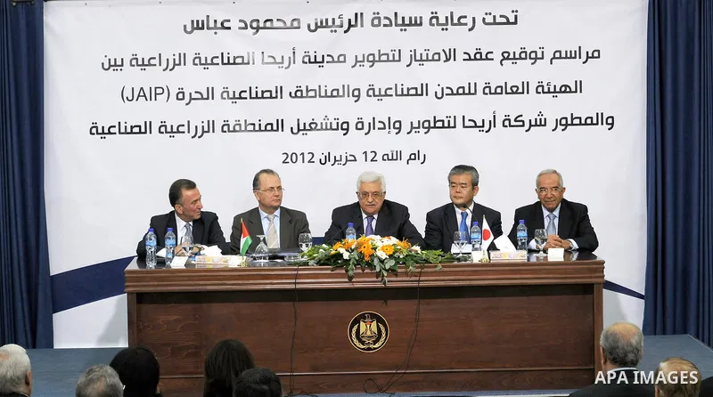 Palestinian President, Mahmoud Abbas (Abu Mazen), signs the franchise agreement with the Japanese government in the West Bank city of Ramallah on June 12, 2012. Photo by Thaer Ganaim