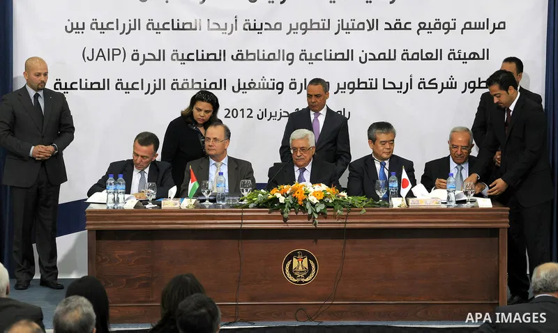 Palestinian President, Mahmoud Abbas (Abu Mazen), signs the franchise agreement with the Japanese government in the West Bank city of Ramallah on June 12, 2012. Photo by Thaer Ganaim