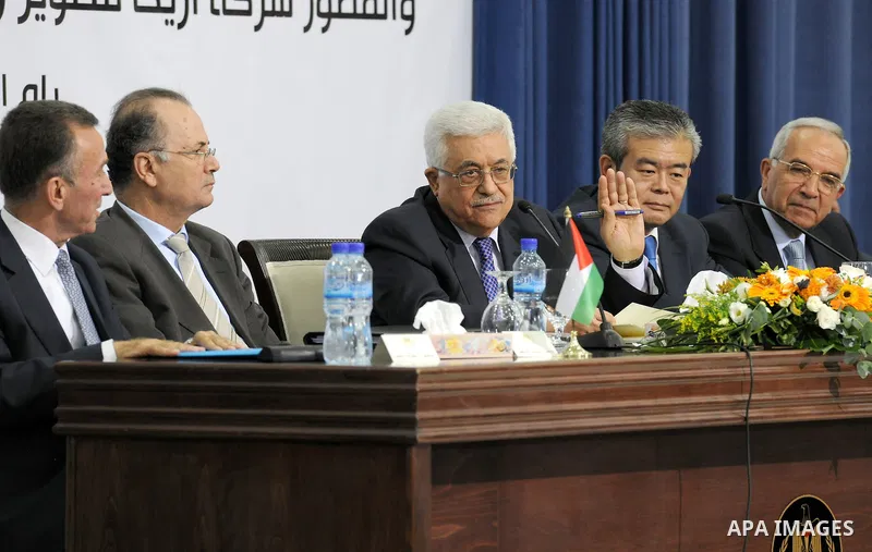 Palestinian President, Mahmoud Abbas (Abu Mazen), signs the franchise agreement with the Japanese government in the West Bank city of Ramallah on June 12, 2012. Photo by Thaer Ganaim