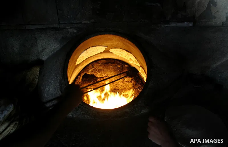 A Palestinian baker prepares bread at his bakery in Rafah, southern Gaza Strip on June 13, 2012. The European Union's envoy to the Palestinian Authority confirmed its support and allegiance to the people. Photo by Eyad A...
