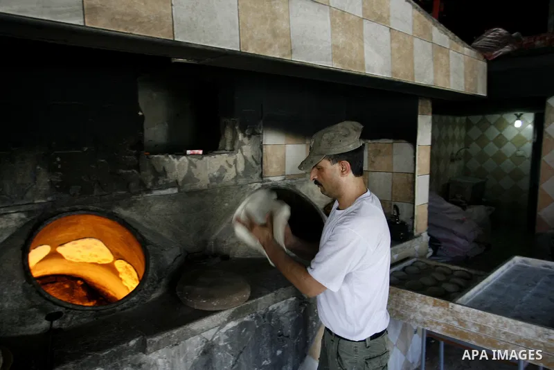A Palestinian baker prepares bread at his bakery in Rafah, southern Gaza Strip on June 13, 2012. The European Union's envoy to the Palestinian Authority confirmed its support and allegiance to the people. Photo by Eyad A...