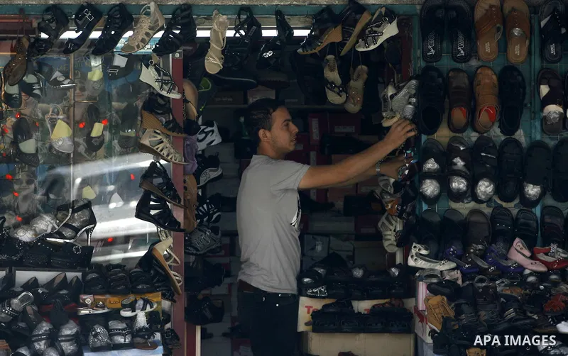 A Palestinian man stands in his shop for shoes at market Rafah, southern Gaza city, on June 13, 2012. The European Union's envoy to the Palestinian Authority confirmed its support and allegiance to the people. Photo by E...