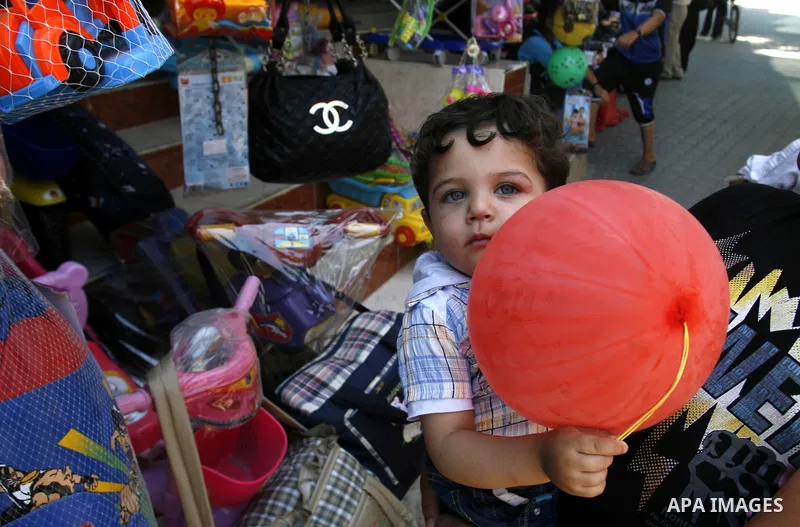 A Palestinian child plays at market Rafah, southern Gaza city, on June 13, 2012. The European Union's envoy to the Palestinian Authority confirmed its support and allegiance to the people. Photo by Eyad Al Baba