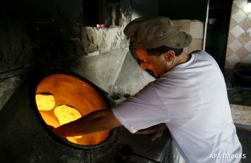 A Palestinian baker prepares bread at his bakery in Rafah, southern Gaza Strip on June 13, 2012. The European Union's envoy to the Palestinian Authority confirmed its support and allegiance to the people. Photo by Eyad A...