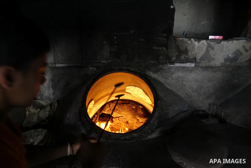 A Palestinian baker prepares bread at his bakery in Rafah, southern Gaza Strip on June 13, 2012. The European Union's envoy to the Palestinian Authority confirmed its support and allegiance to the people. Photo by Eyad A...