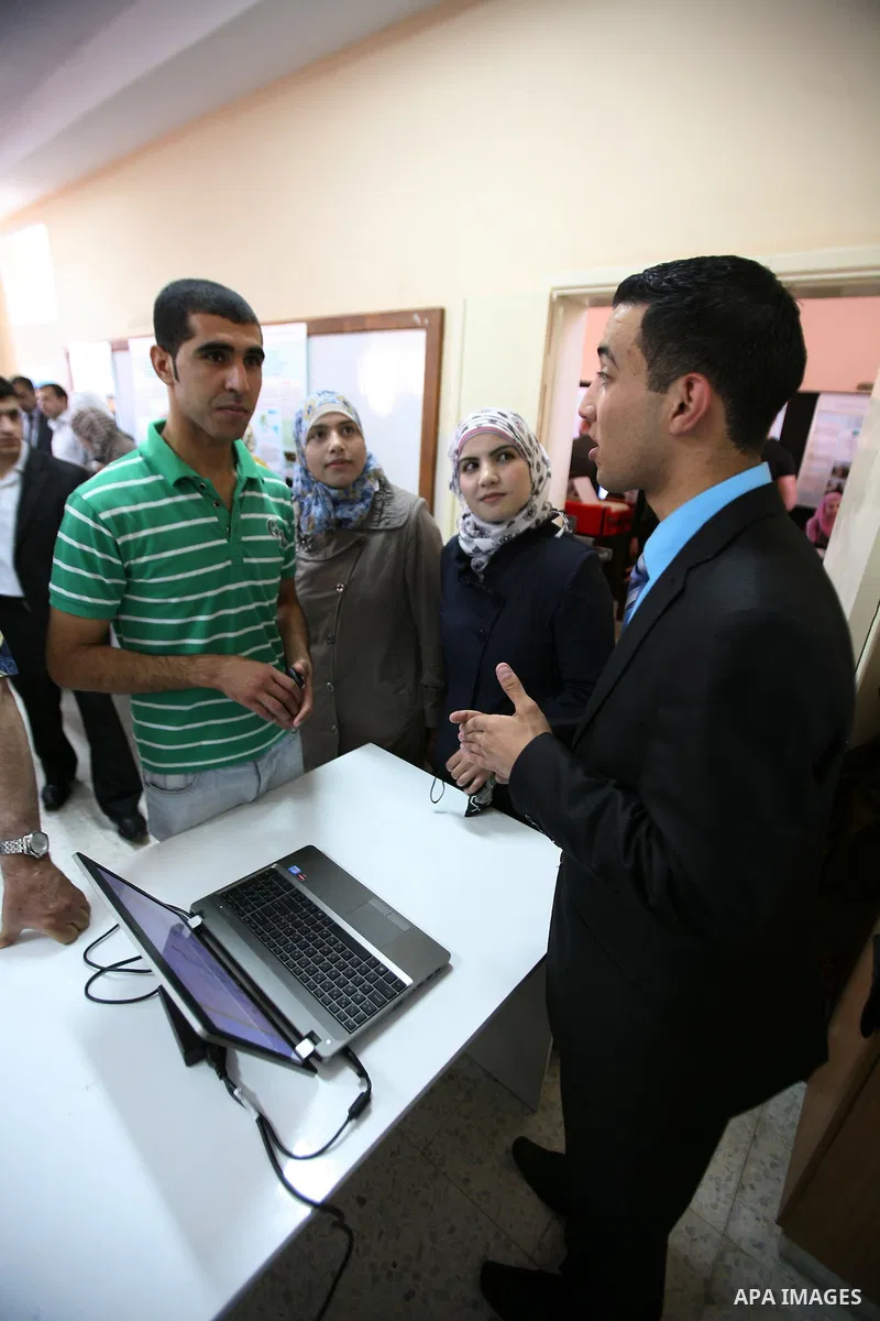 Palestinian students participate in the exhibition of "Creativity of the student" at the Palestine Polytechnic University in the West Bank city of Hebron on 13 June 2012. Photo by Mamoun Wazwaz