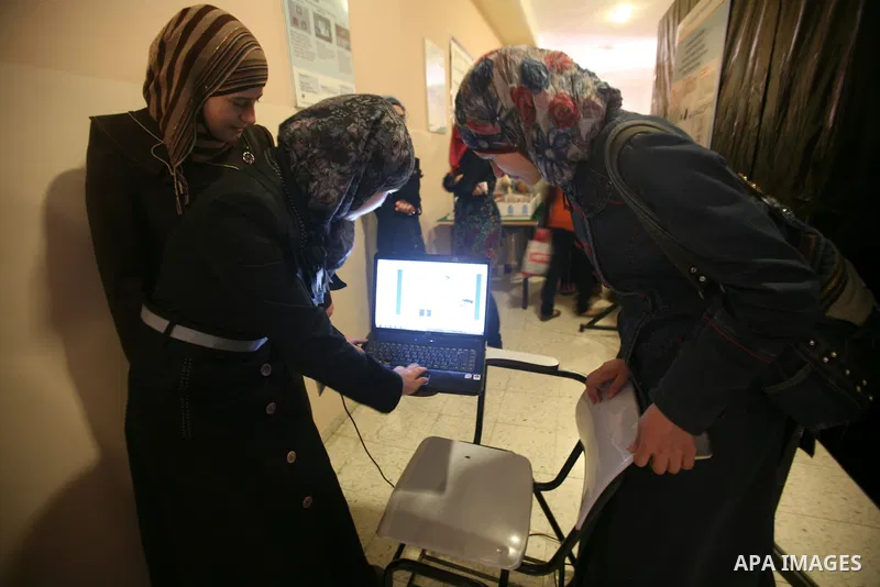 Palestinian students participate in the exhibition of "Creativity of the student" at the Palestine Polytechnic University in the West Bank city of Hebron on 13 June 2012. Photo by Mamoun Wazwaz
