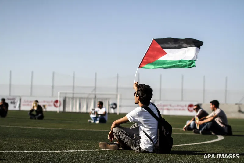 Palestinian athletes hold pictures and banners for prisoner Mahmoud Sarsak, a former player with the Palestinian national football team held in Israeli jails, during a protest calling for release him, at Al-Bireh playgro...