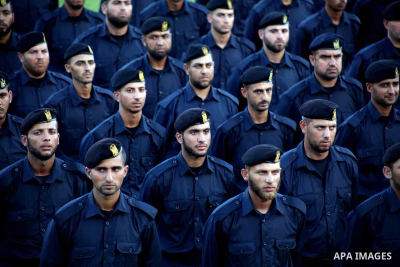 Graduating police officers stand to attention during a ceremony at the police academy in Gaza City on June 13, 2012, making them the first batch of officers to graduate after four years of training under the Hamas leader...