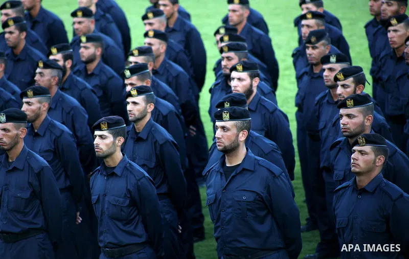 Graduating police officers stand to attention during a ceremony at the police academy in Gaza City on June 13, 2012, making them the first batch of officers to graduate after four years of training under the Hamas leader...