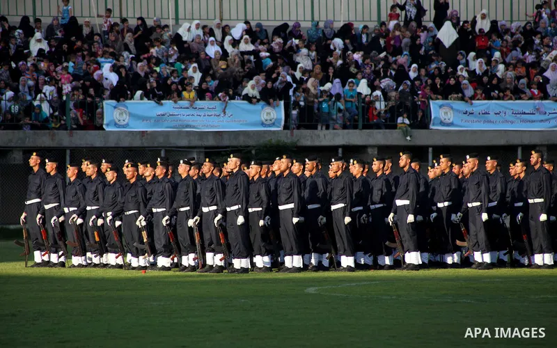 Graduating police officers stand to attention during a ceremony at the police academy in Gaza City on June 13, 2012, making them the first batch of officers to graduate after four years of training under the Hamas leader...