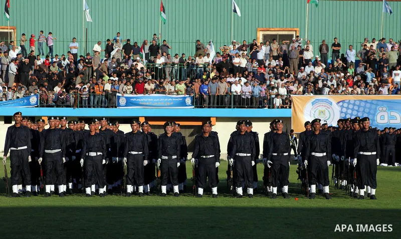 Graduating police officers stand to attention during a ceremony at the police academy in Gaza City on June 13, 2012, making them the first batch of officers to graduate after four years of training under the Hamas leader...