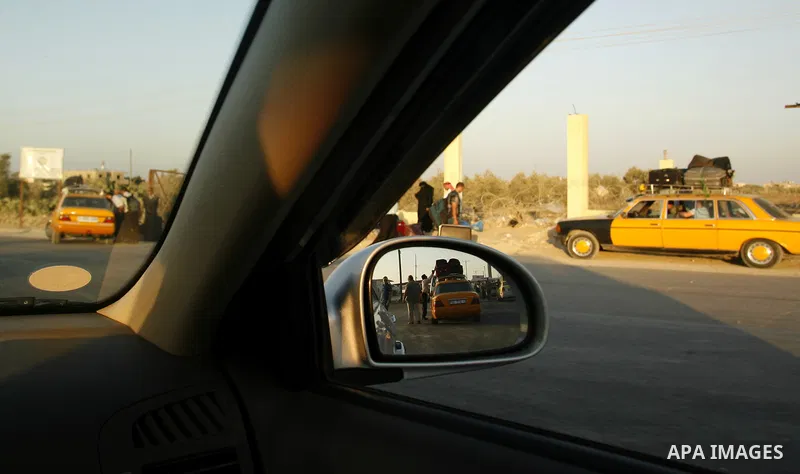 Palestinians load their luggage as they wait to cross into Egypt through the Rafah border crossing in the southern Gaza Strip on June 13, 2013. After the stopping of the Rafah border crossing from the Egyptian side Becau...