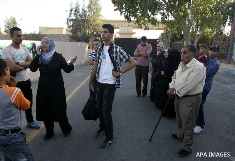 Palestinians load their luggage as they wait to cross into Egypt through the Rafah border crossing in the southern Gaza Strip on June 13, 2013. After the stopping of the Rafah border crossing from the Egyptian side Becau...