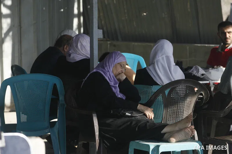 Palestinians load their luggage as they wait to cross into Egypt through the Rafah border crossing in the southern Gaza Strip on June 13, 2013. After the stopping of the Rafah border crossing from the Egyptian side Becau...