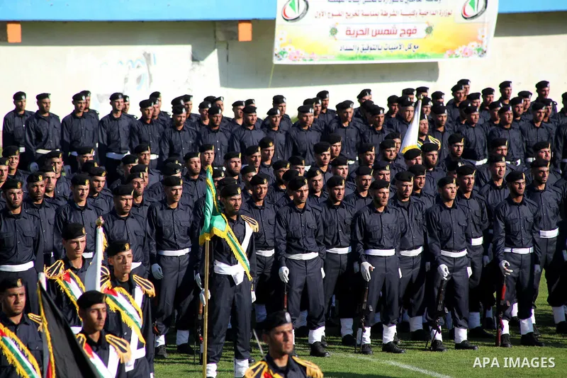 Graduating police officers stand to attention during a ceremony at the police academy in Gaza City on June 13, 2012, making them the first batch of officers to graduate after four years of training under the Hamas leader...
