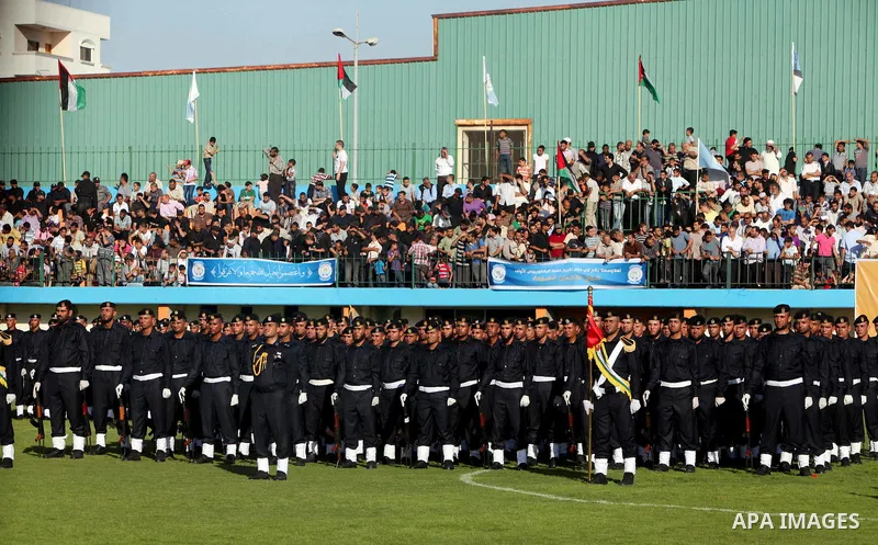 Graduating police officers stand to attention during a ceremony at the police academy in Gaza City on June 13, 2012, making them the first batch of officers to graduate after four years of training under the Hamas leader...