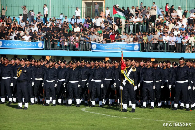 Graduating police officers stand to attention during a ceremony at the police academy in Gaza City on June 13, 2012, making them the first batch of officers to graduate after four years of training under the Hamas leader...