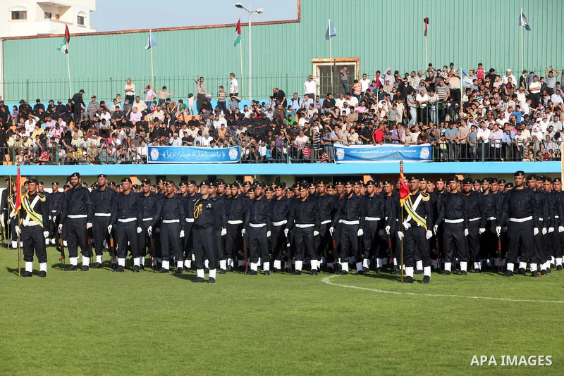 Graduating police officers stand to attention during a ceremony at the police academy in Gaza City on June 13, 2012, making them the first batch of officers to graduate after four years of training under the Hamas leader...