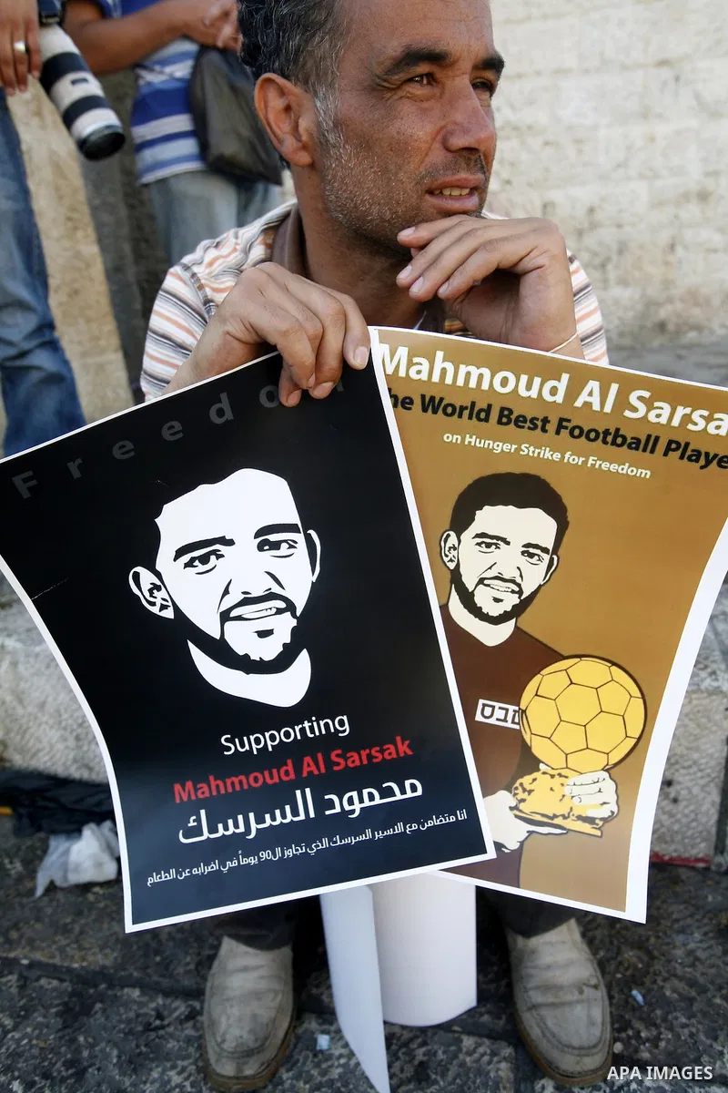 Palestinians hold posters depicting footballer Mahmoud Al-Sarsak, who is protesting his alleged illegal detention by Israel, during a rally in the old city of Jerusalem on June 13, 2012. FIFA president Sepp Blatter has e...