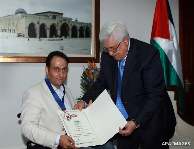 Palestinian President, Mahmoud Abbas (Abu Mazen) honors Osama Silwadi the Medal Of Merit and Excellence, in the West Bank city of Ramallah, on June 14, 2012. Photo by Thaer Ganaim