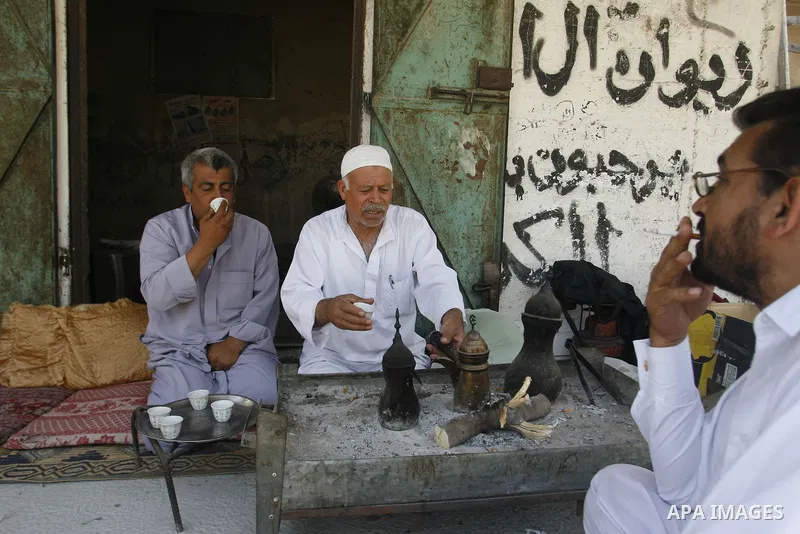 Palestinians drink the coffee near the home in Rafah refugee camp, southern Gaza city, on June 14, 2012. Photo by Eyad Al Baba