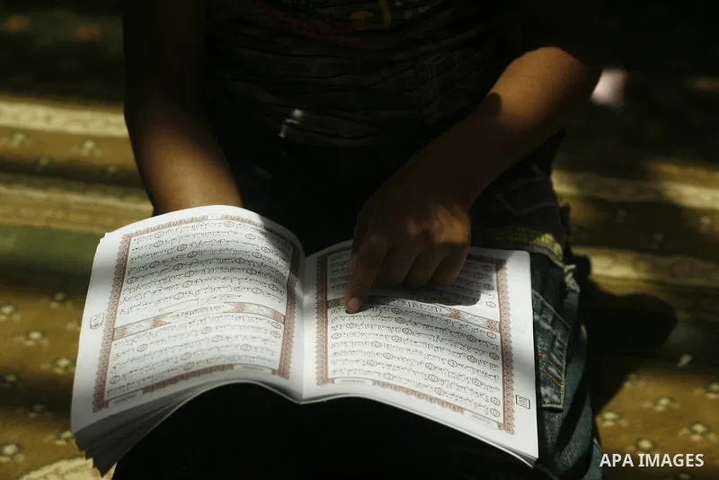 A Palestinian boy reads verses from the Quran during a class on how to read Islam's holy book, at a mosque in Rafah, southern Gaza city, on June 14, 2012. A summer camp in the Gaza Strip, 'Crown of Dignity IV', plans to...