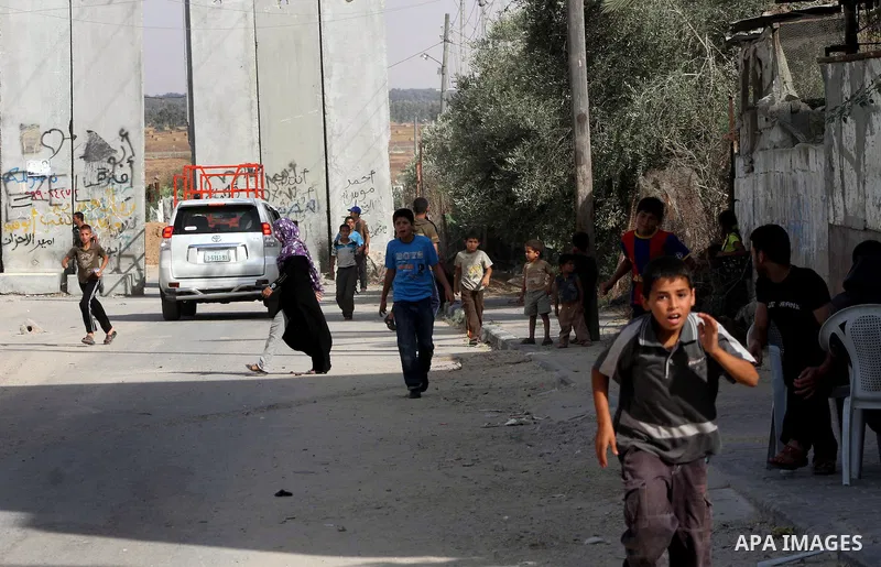 Palestinians gather near Khuza'a town , in the east of Khan Younis city in the south of gaza strip during raids of Israeli helicopters and tanks on 14 June 2012. Palestinian medical sources confirmed the presence of inju...
