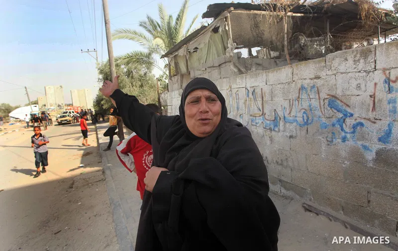 A Palestinian woman screams during raids of Israeli helicopters and tanks on Khuza'a town , in the east of Khan Younis city in the south of gaza strip, on 14 June 2012. Palestinian medical sources confirmed the presence...