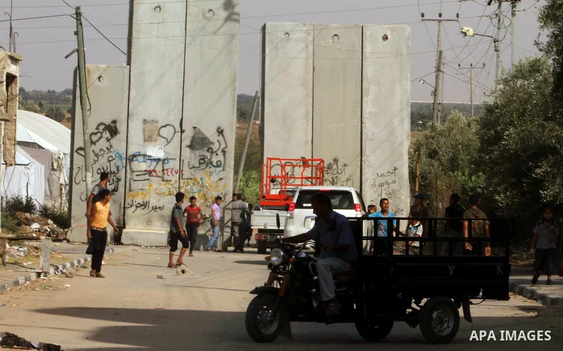 Palestinians gather near Khuza'a town , in the east of Khan Younis city in the south of gaza strip during raids of Israeli helicopters and tanks on 14 June 2012. Palestinian medical sources confirmed the presence of inju...