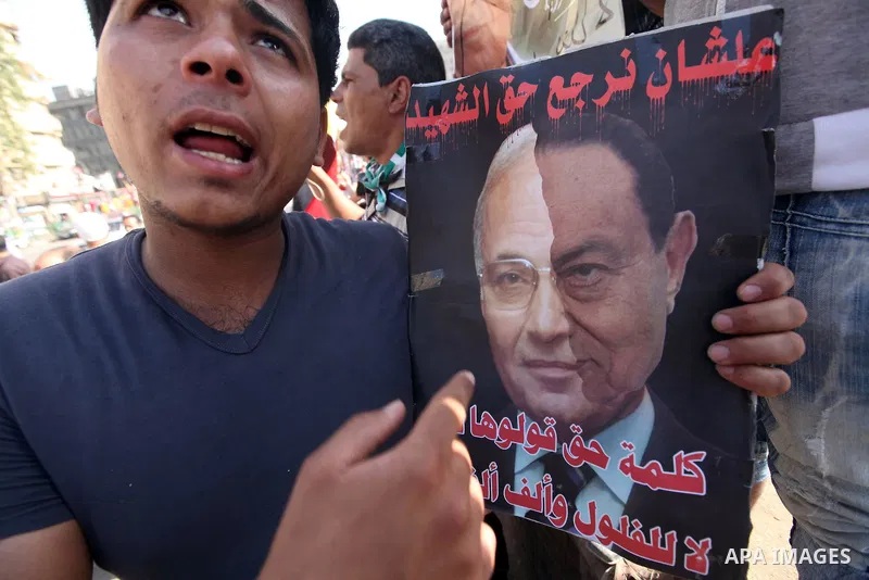 An Egyptian protester holds a placard against presidential candidate Ahmed Shafik during a protest at Cairo's Tahrir square, Egypt, 14 June 2012. Media reports on 14 June state that the Supreme Constitutional Court ruled...