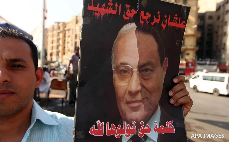An Egyptian protester holds a placard against presidential candidate Ahmed Shafik during a protest at Cairo's Tahrir square, Egypt, 14 June 2012. Media reports on 14 June state that the Supreme Constitutional Court ruled...
