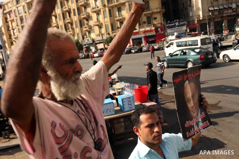 An Egyptian protester holds a placard against presidential candidate Ahmed Shafik during a protest at Cairo's Tahrir square, Egypt, 14 June 2012. Media reports on 14 June state that the Supreme Constitutional Court ruled...