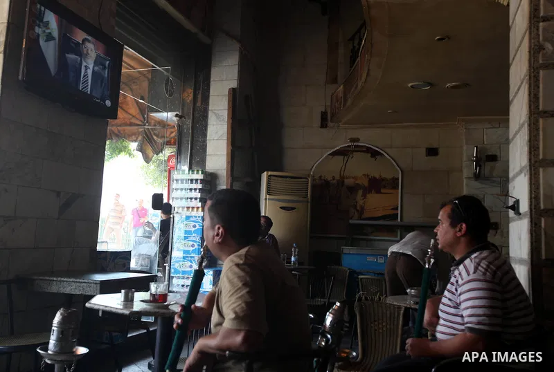 Egyptians watch television in a cafe at Cairo's Tahrir square, Egypt, 14 June 2012. Media reports on 14 June state that the Supreme Constitutional Court ruled that Ahmed Shafik could stand in the presidential election ru...