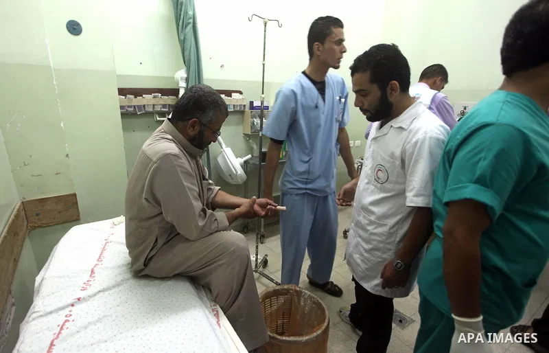 A Palestinian medic checks a wounded man at Naser hospital following an Israeli strike on June 14, 2012 in Khuza'a town , in the east of Khan Younis city in the south of gaza strip. Photo by Ashraf Amra
