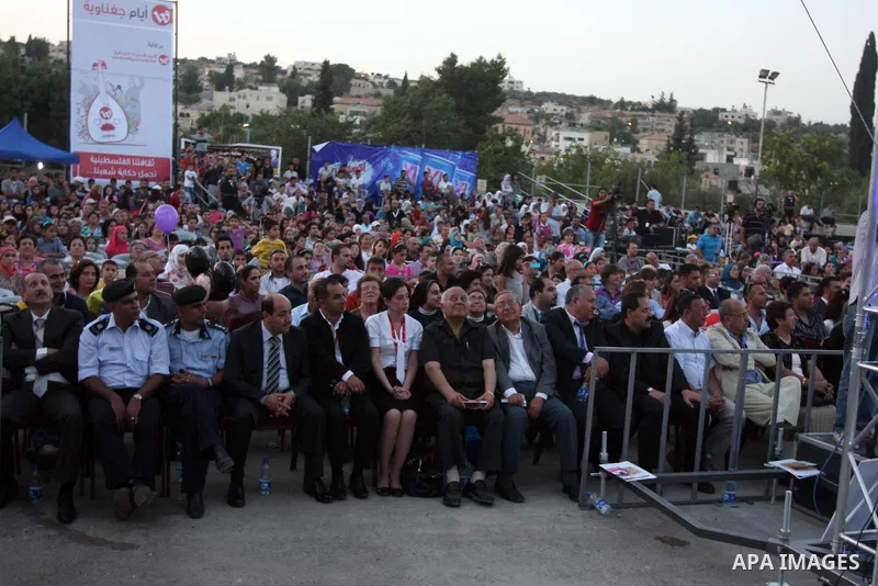 Palestinians take part in the opening of "Apricot Exhibition" in the village of Jaffna in the West Bank city of Ramallah, Thursday June 14, 2012. Photo by Issam Rimawi