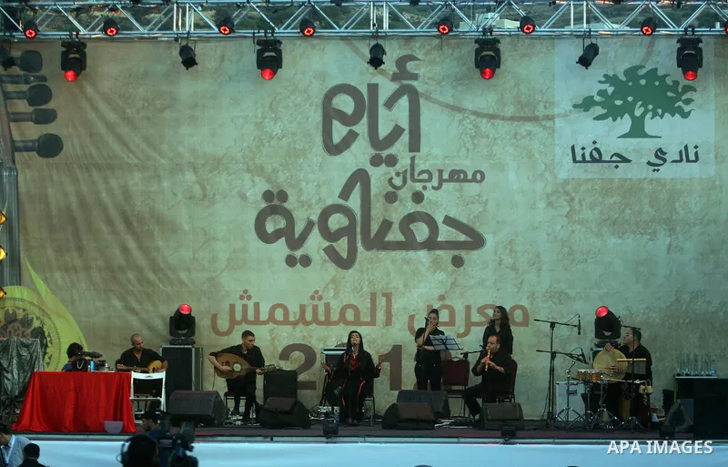 Palestinians take part in the opening of "Apricot Exhibition" in the village of Jaffna in the West Bank city of Ramallah, Thursday June 14, 2012. Photo by Issam Rimawi