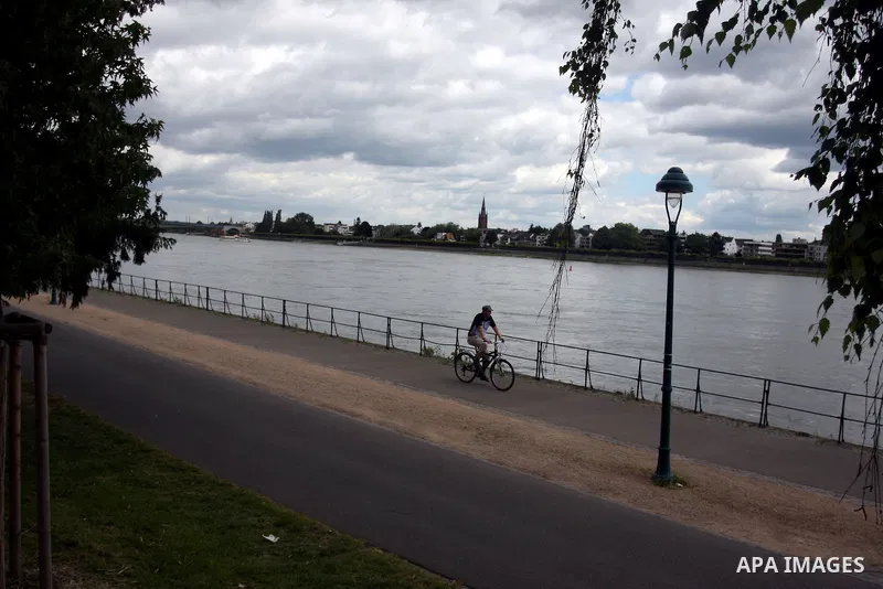 A German man rides a bicycle near the river Rhine near the city of Bonn in Germany on 15 June 2012. The Rhine is one of the longest and most important rivers in Europe. It runs for over 1,232 km .Rhine flows through six...