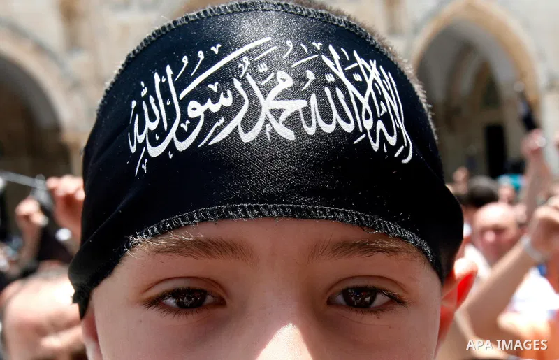 Dozens of members of the Islamic Liberation Movement, take part in a rally to mark anniversary of the overthrow of the Islamic Caliphate at Al-Aqsa Mosque following the friday prayers in the Jerusalem old city on 15 June...