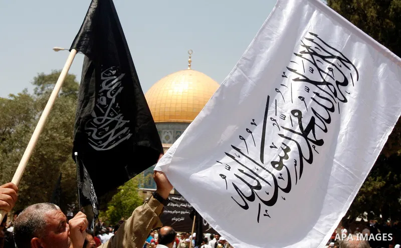 Dozens of members of the Islamic Liberation Movement, take part in a rally to mark anniversary of the overthrow of the Islamic Caliphate at Al-Aqsa Mosque following the friday prayers in the Jerusalem old city on 15 June...