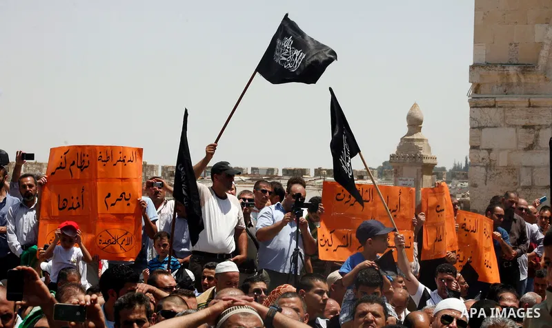 Dozens of members of the Islamic Liberation Movement, take part in a rally to mark anniversary of the overthrow of the Islamic Caliphate at Al-Aqsa Mosque following the friday prayers in the Jerusalem old city on 15 June...