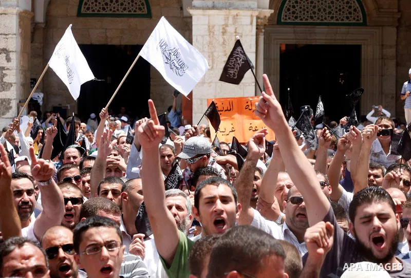 Dozens of members of the Islamic Liberation Movement, take part in a rally to mark anniversary of the overthrow of the Islamic Caliphate at Al-Aqsa Mosque following the friday prayers in the Jerusalem old city on 15 June...