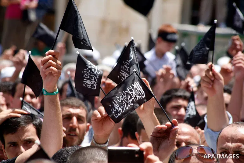 Dozens of members of the Islamic Liberation Movement, take part in a rally to mark anniversary of the overthrow of the Islamic Caliphate at Al-Aqsa Mosque following the friday prayers in the Jerusalem old city on 15 June...