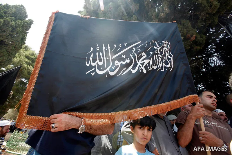 Dozens of members of the Islamic Liberation Movement, take part in a rally to mark anniversary of the overthrow of the Islamic Caliphate at Al-Aqsa Mosque following the friday prayers in the Jerusalem old city on 15 June...