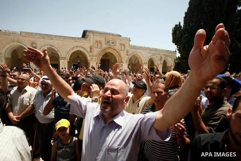 Dozens of members of the Islamic Liberation Movement, take part in a rally to mark anniversary of the overthrow of the Islamic Caliphate at Al-Aqsa Mosque following the friday prayers in the Jerusalem old city on 15 June...