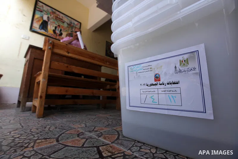 An Egyptian employee prepares a polling station on June 15, 2012 on the eve of Egypt's second round of presidential runoff elections. Egypt's transition to democracy was thrown into further disarray after its top court o...