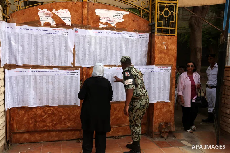 A voter checks her name at a polling station in Cairo June 16, 2012. Egypt's first free presidential election concludes this weekend in a run-off between the Muslim Brotherhood's candidate Mohamed Morsy and Ahmed Shafik,...